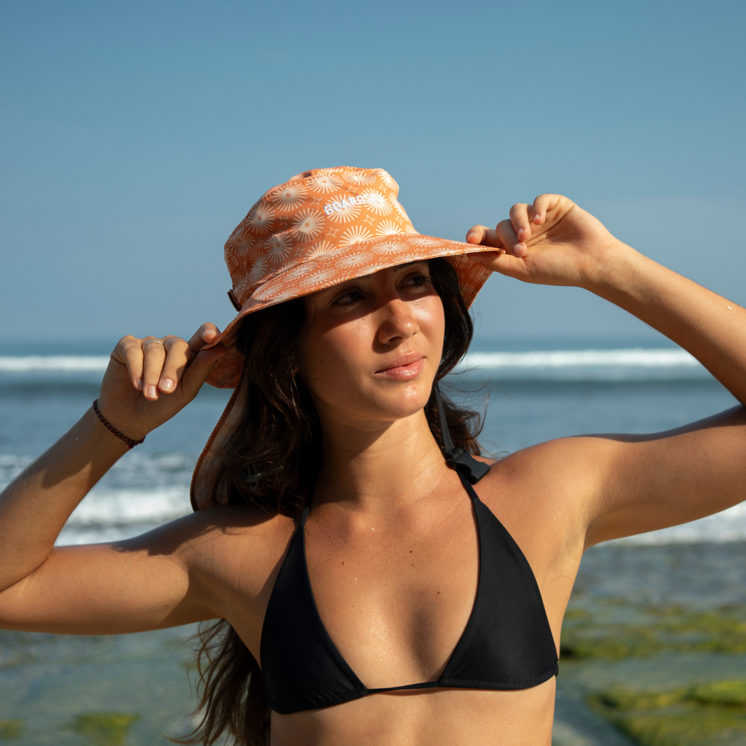 Sunny Beachley Boardsox surf hat in cream with a soft orange print