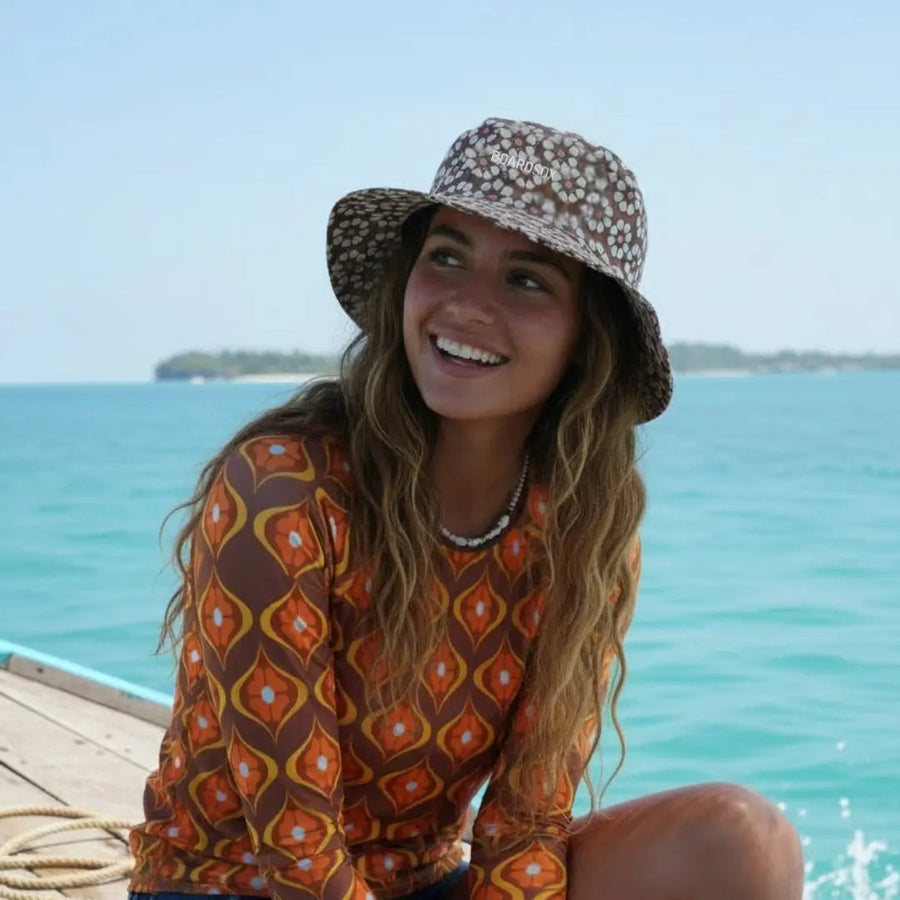Coco Boardsox surf hat in cream with a brown daisy print with hard shell insert